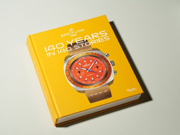 The 140 Years in 140 Stories commemorative book.