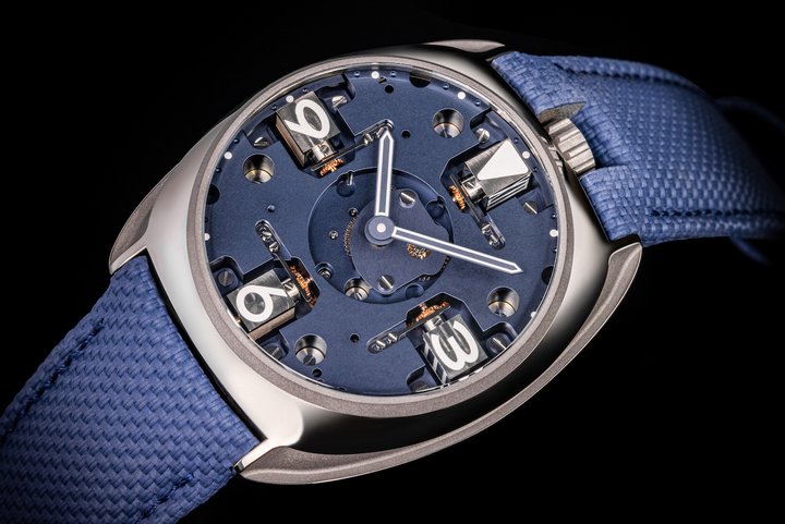 The Meca, released in May 2024, with openworked dial and crown at 12 o'clock. Shown here with Arabic numerals.