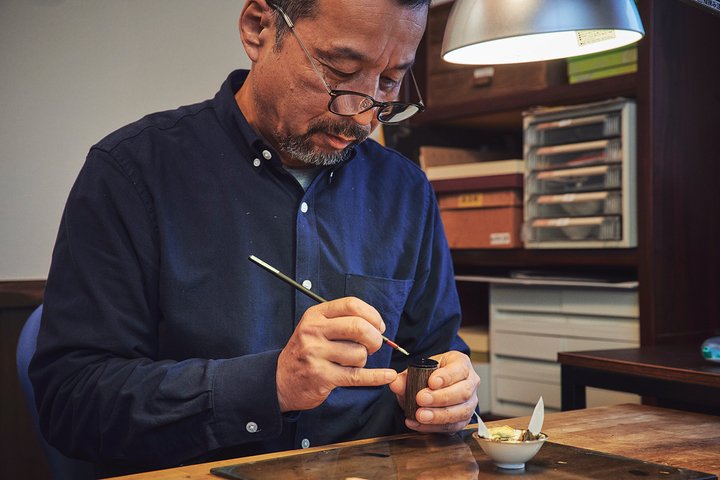 Nobuichi Otake working on a dial using the raden technique, which combines inlays of crushed seashell with urushi lacquer.