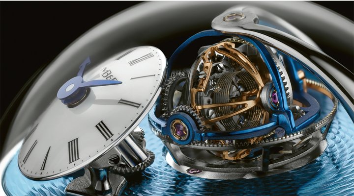 The MB&F Legacy Machine Thunderdome, jointly signed by Eric Coudray and Kari Voutilainen. Rising above a sea of blue guillochage is a rotating spherical mass of gears, pinions and cages. The proprietary “TriAx” mechanism features 3 axles revolving at different speeds and on different planes, in 8, 12 and 20' seconds.