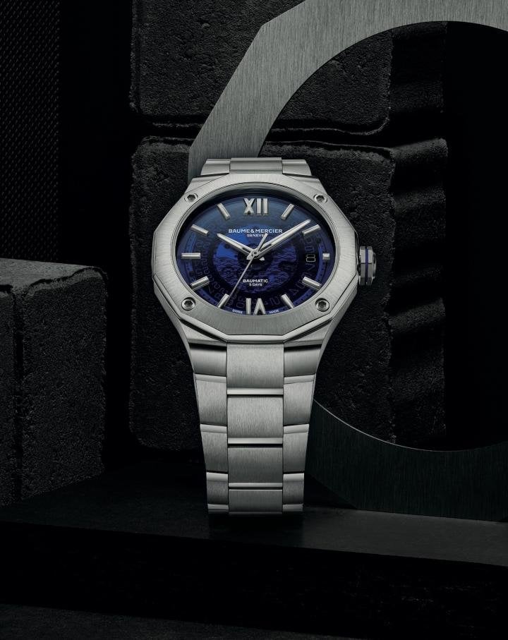 The 42-mm Baumatic Riviera is available with a smoky blue decorated sapphire dial on an integral steel bracelet, or with a smoky gray decorated sapphire dial on a supple black strap. The transparency of its translucent dial provides an opportunity to admire the moving gear trains of the calibre.